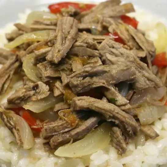 Arroz con mechada cerdo y juguito