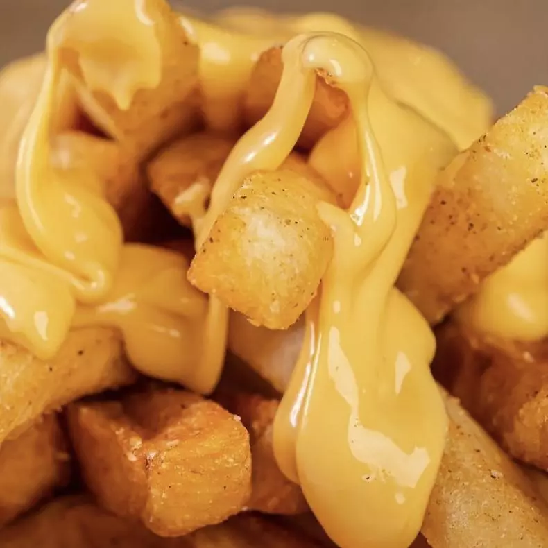 Porción de Papas Fritas con cheddar